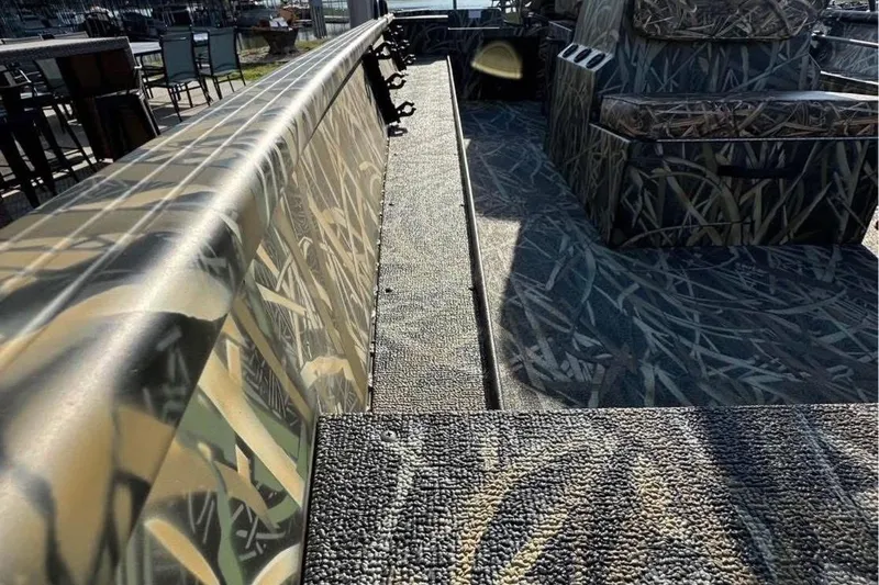 Slide: The Image of 2026 Smoker Craft Sportsman 1866 boat interior with camouflage design and seating. - 6