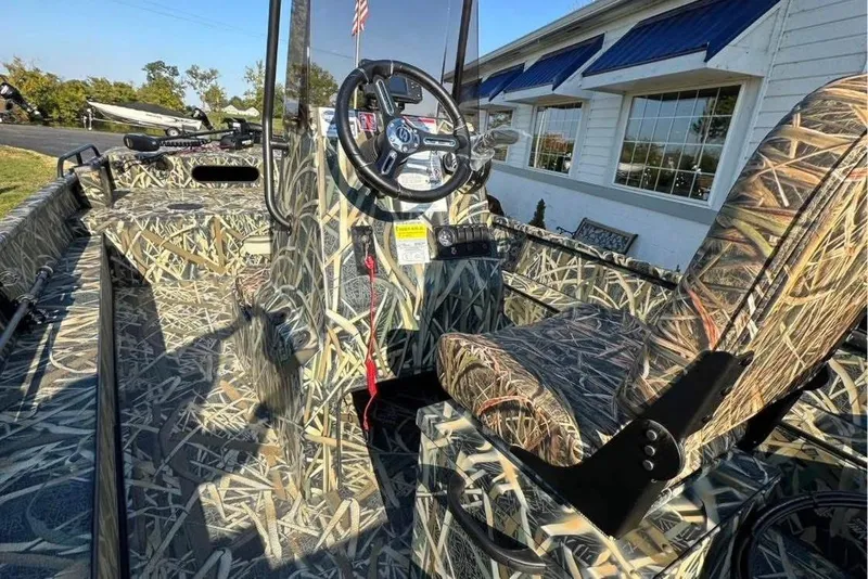 Slide: The Image of 2026 Smoker Craft Sportsman 1866 boat with camouflage interior and steering console. - 7