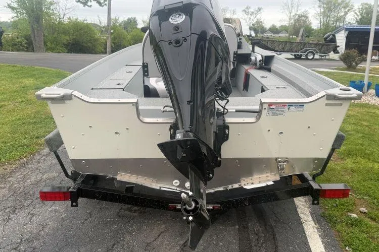 Slide: The Image of 2026 Smoker Craft Angler 16 SC boat with outboard motor, parked on a trailer. - 3