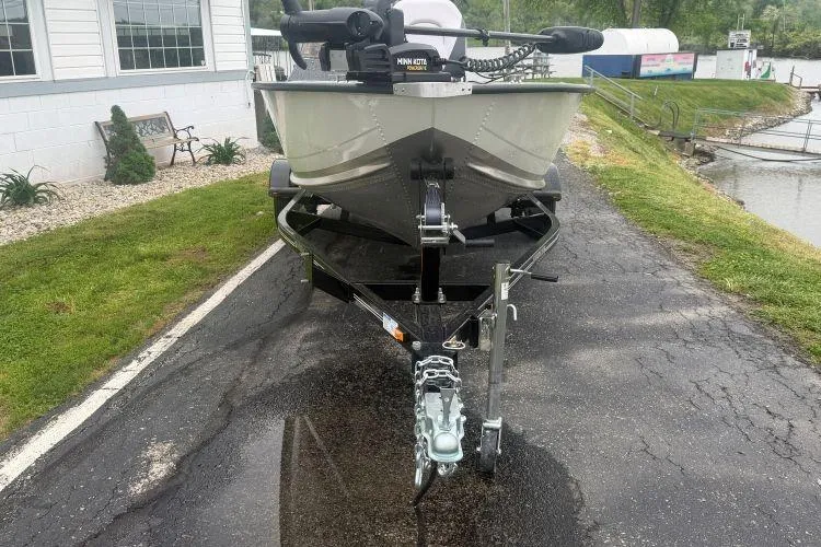 Slide: The Image of 2026 Smoker Craft Angler 16 SC boat on trailer, parked near a waterfront. - 4