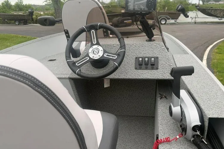 Slide: The Image of 2026 Smoker Craft Angler 16 SC boat interior with steering wheel and control panel. - 6