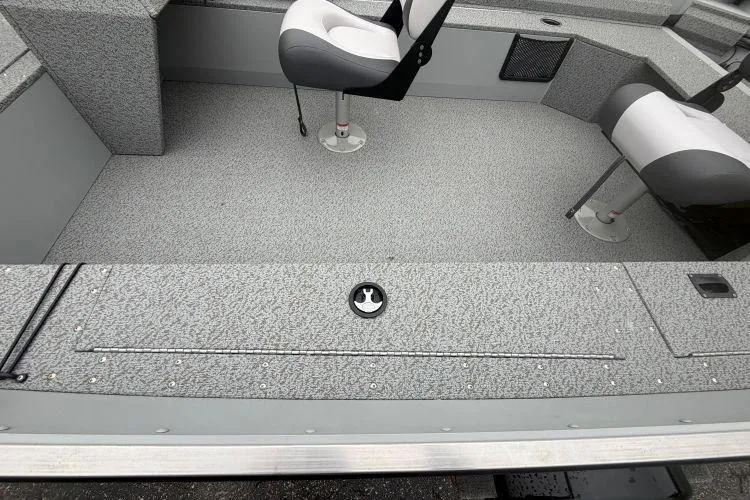Slide: The Image of 2026 Smoker Craft Angler 16 SC boat interior with gray textured flooring and swivel seats. - 8