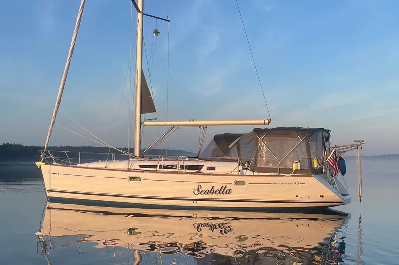 Slide: The Image of 2006 Jeanneau Sun Odyssey 45 sailboat named Seabella on calm water at sunrise. - 3