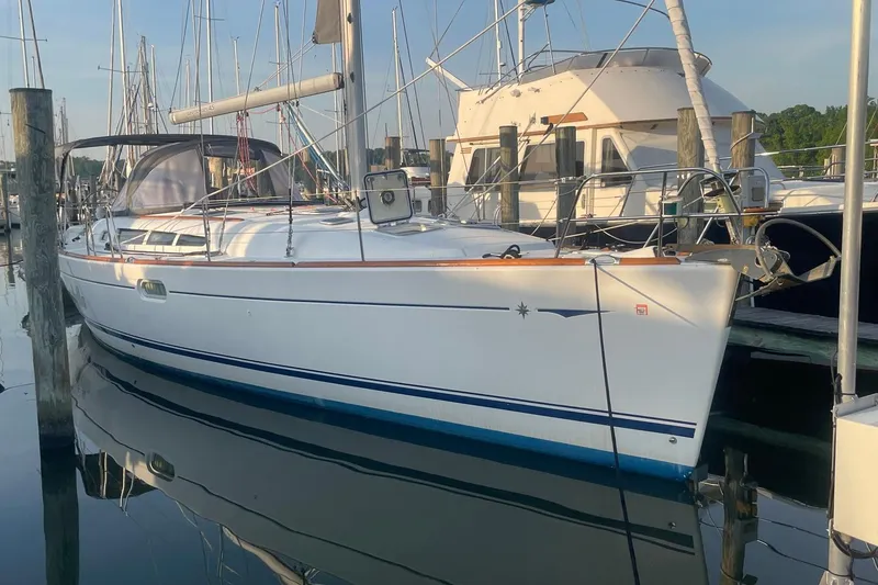 Slide: The Image of 2006 Jeanneau Sun Odyssey 45 sailboat docked at marina, reflecting on calm water. - 5