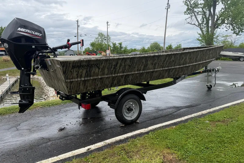 The Image of 2026 Smoker Craft 1448 Jon boat with Mercury outboard motor on trailer. - 0