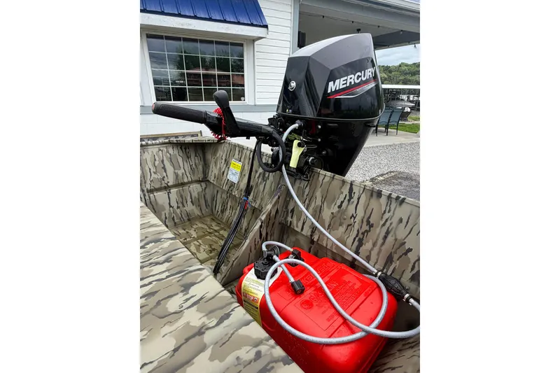 Slide: The Image of 2026 Smoker Craft 1448 Jon boat with Mercury outboard motor and red fuel tank. - 5