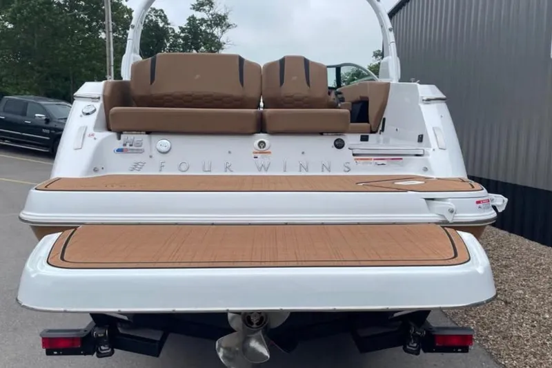 Slide: The Image of 2026 Four Winns H6 boat rear view with teak swim platform and seating. - 3