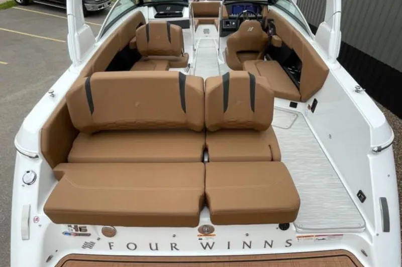 Slide: The Image of 2026 Four Winns H6 boat interior with tan seating and modern design. - 4