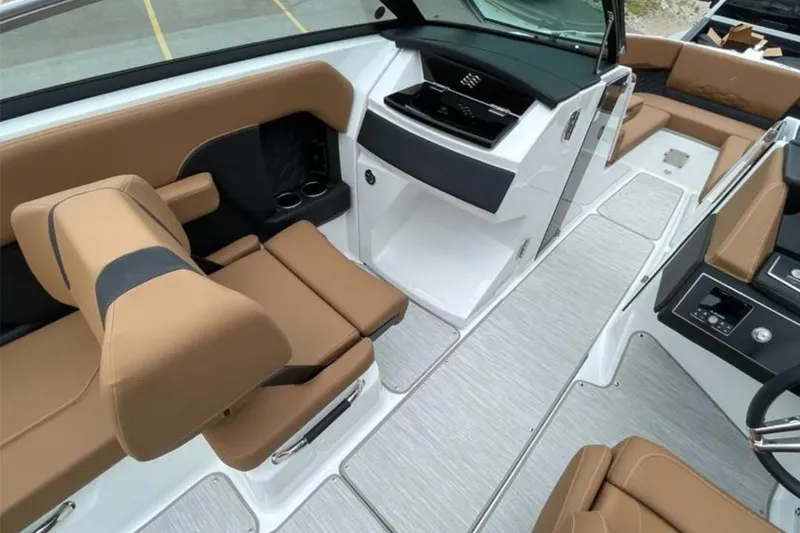Slide: The Image of Interior of 2026 Four Winns H6 boat with tan seating and modern design. - 6
