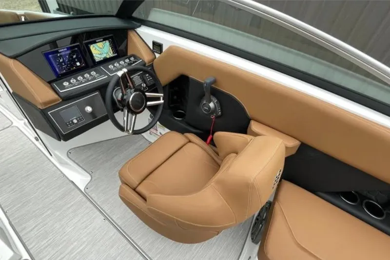 Slide: The Image of 2026 Four Winns H6 boat cockpit with modern controls and tan seating. - 7