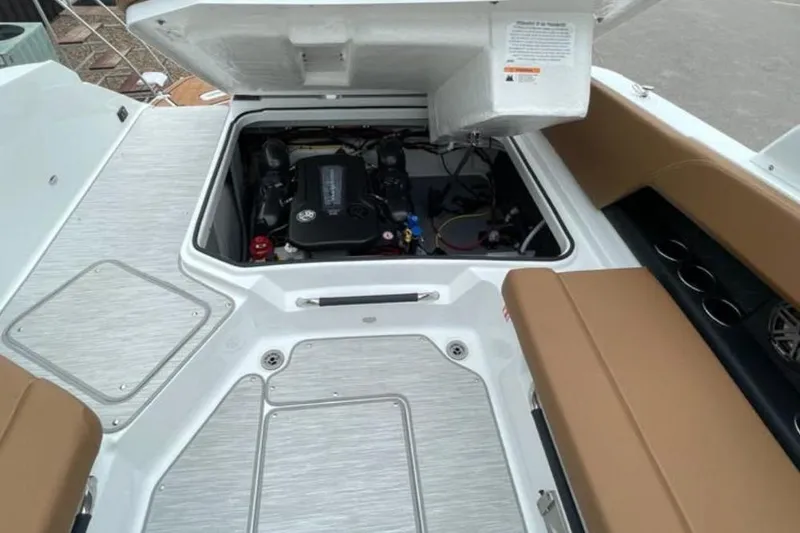 Slide: The Image of Open engine compartment of 2026 Four Winns H6 boat, showcasing interior mechanics and seating area. - 9