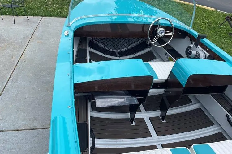 Slide: The Image of Turquoise 2026 Starcraft 57 Ski Champ boat with sleek interior and classic steering wheel design. - 4