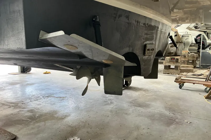 Slide: The Image of 2005 Cruisers Yachts 370 Express propeller and hull in a workshop setting. - 11