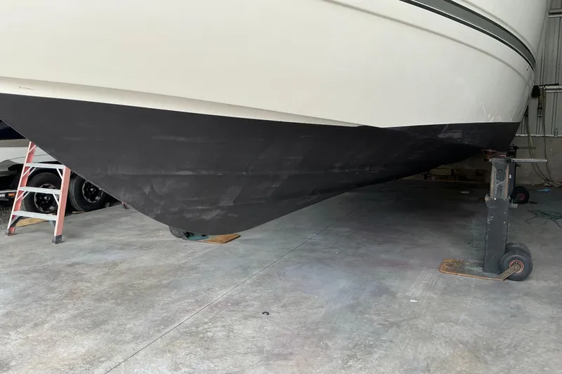 Slide: The Image of 2005 Cruisers Yachts 370 Express boat hull in a maintenance facility. - 12