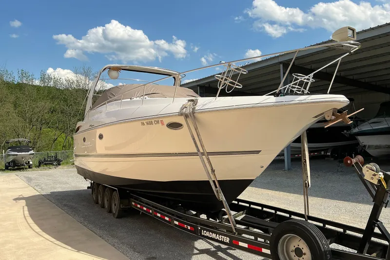 Slide: The Image of 2005 Cruisers Yachts 370 Express on trailer under clear blue sky. - 2