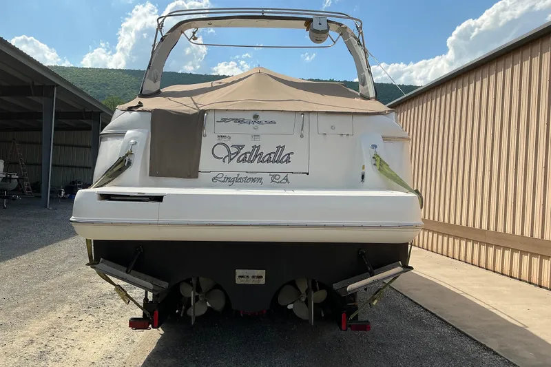 Slide: The Image of 2005 Cruisers Yachts 370 Express boat docked, rear view with cover, sunny day. - 5