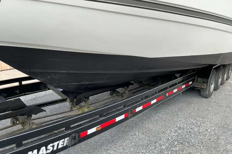 Slide: The Image of 2005 Cruisers Yachts 370 Express on trailer, side view of hull and wheels. - 8
