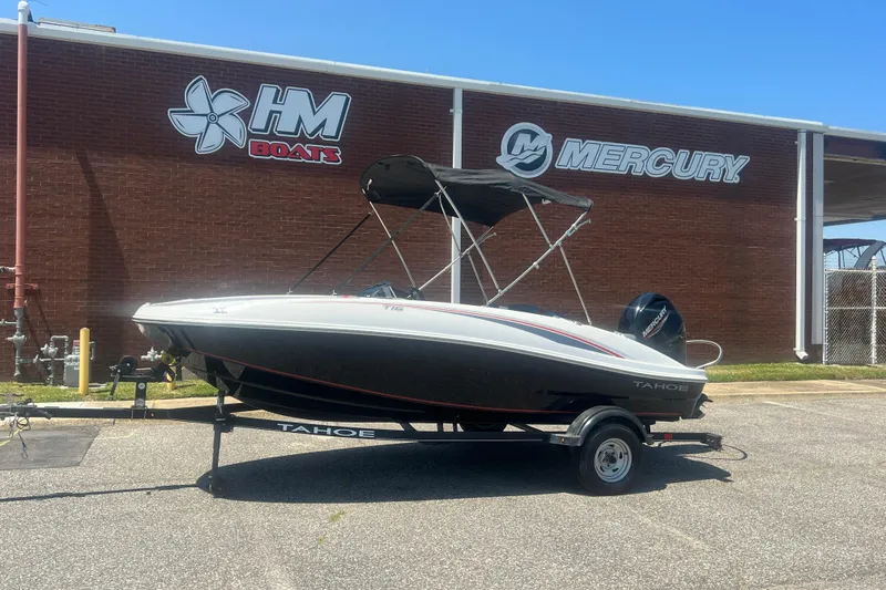 The Image of 2023 Tahoe T16 boat on trailer outside HM Boats and Mercury building. - 1