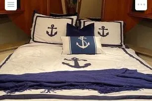 Slide: The Image of Nautical-themed bedding with anchor designs in a 2008 Cruisers Yachts 560 Express cabin. - 12