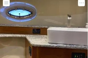 Slide: The Image of Luxurious bathroom interior of 2008 Cruisers Yachts 560 Express with modern sink and porthole. - 14