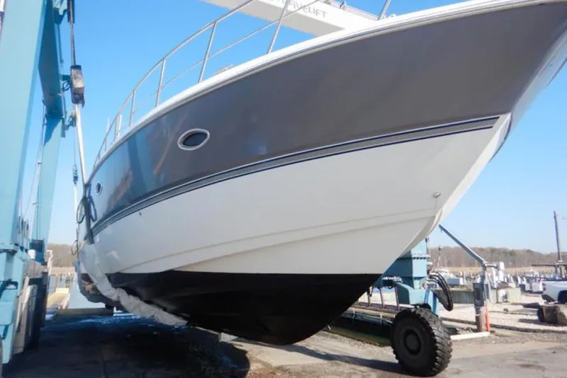 Slide: The Image of 2008 Cruisers Yachts 560 Express on a lift, showcasing sleek design and craftsmanship. - 2