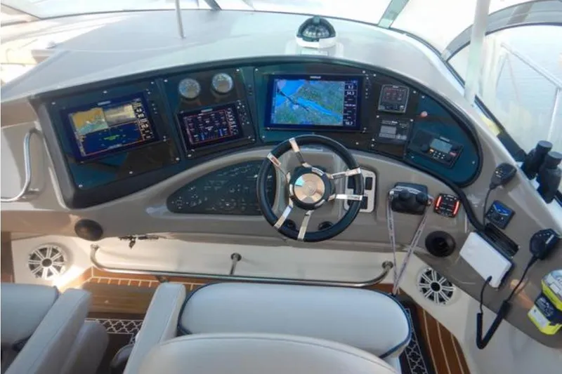 Slide: The Image of 2008 Cruisers Yachts 560 Express helm with advanced navigation displays and controls. - 4