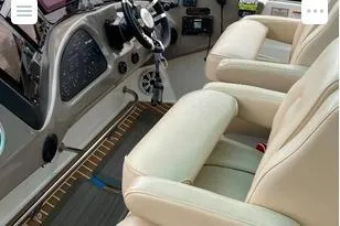 Slide: The Image of 2008 Cruisers Yachts 560 Express helm with beige leather seats and modern controls. - 5