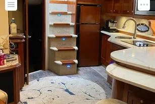 Slide: The Image of Luxurious interior of 2008 Cruisers Yachts 560 Express with modern kitchen and elegant staircase. - 7