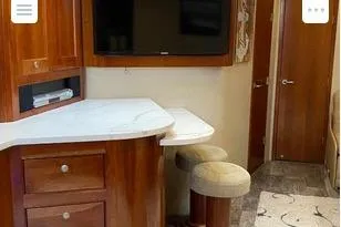 Slide: The Image of Interior of 2008 Cruisers Yachts 560 Express with wooden cabinetry and modern amenities. - 9