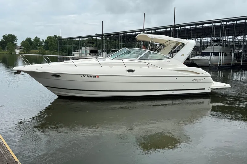 Slide: The Image of 2004 Cruisers Yachts 320 Express boat docked on calm water. - 2