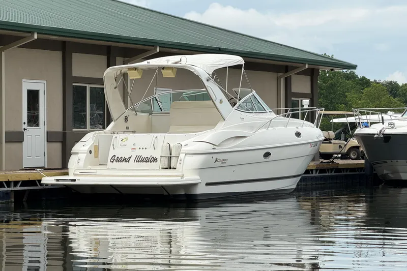 Slide: The Image of 2004 Cruisers Yachts 320 Express docked, featuring sleek design and white exterior. - 3