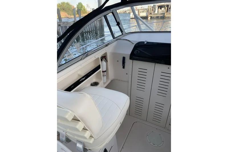 Slide: The Image of 2001 Grady-White Seafarer 226 boat interior with white seating and storage compartments. - 10