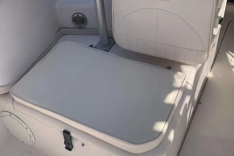 Slide: The Image of 2001 Grady-White Seafarer 226 boat interior seating area with white cushioned seat. - 11