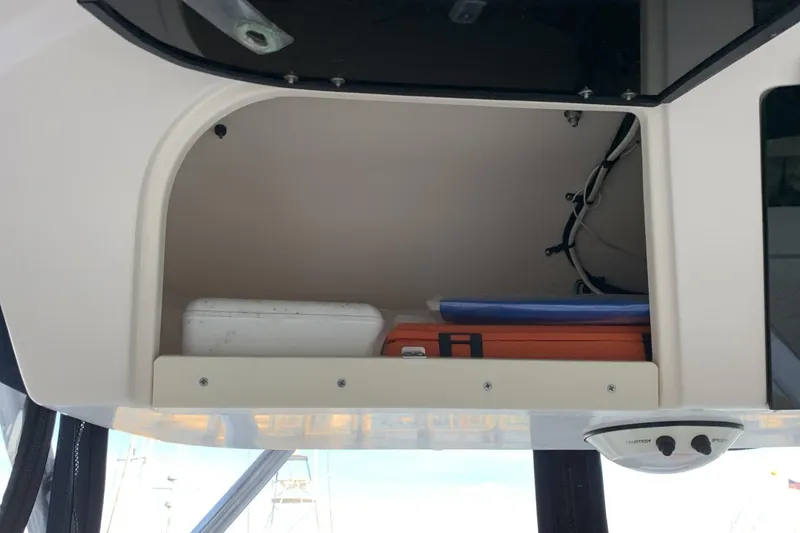 Slide: The Image of Storage compartment in a 2001 Grady-White Seafarer 226 boat with equipment and wiring. - 18