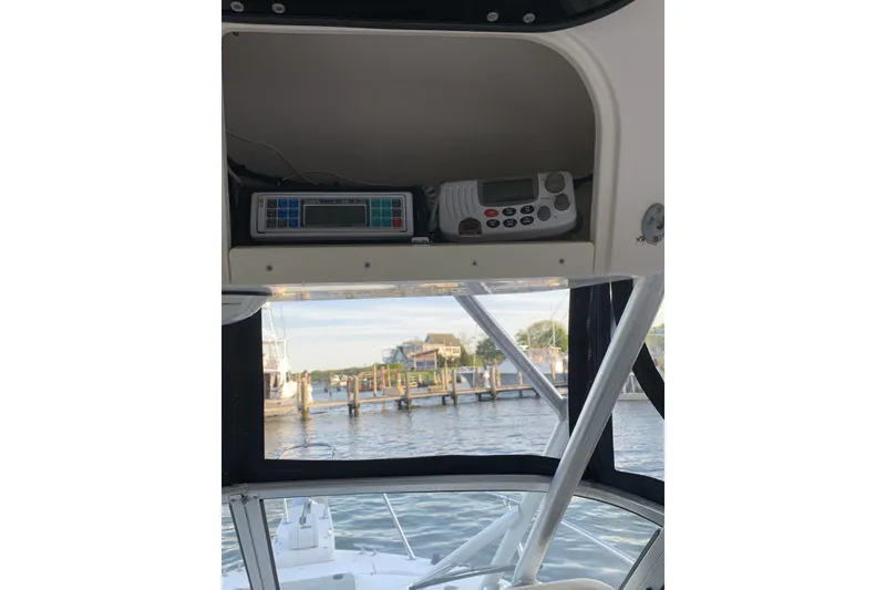 Slide: The Image of 2001 Grady-White Seafarer 226 boat interior with electronics and marina view. - 19