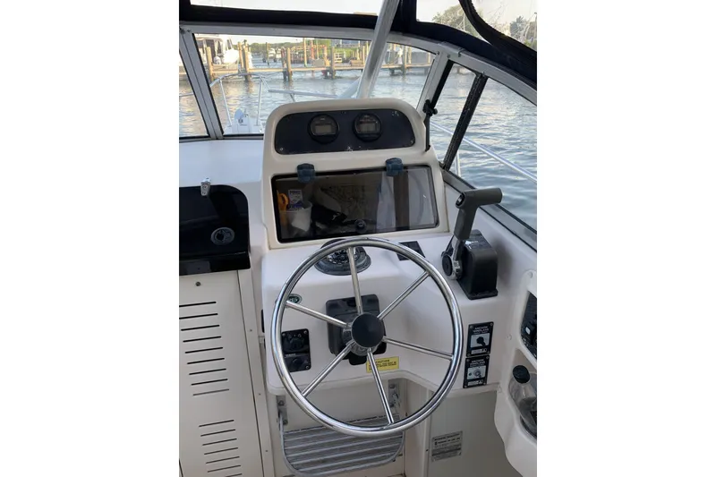 Slide: The Image of Helm of 2001 Grady-White Seafarer 226 boat with steering wheel and controls. - 4