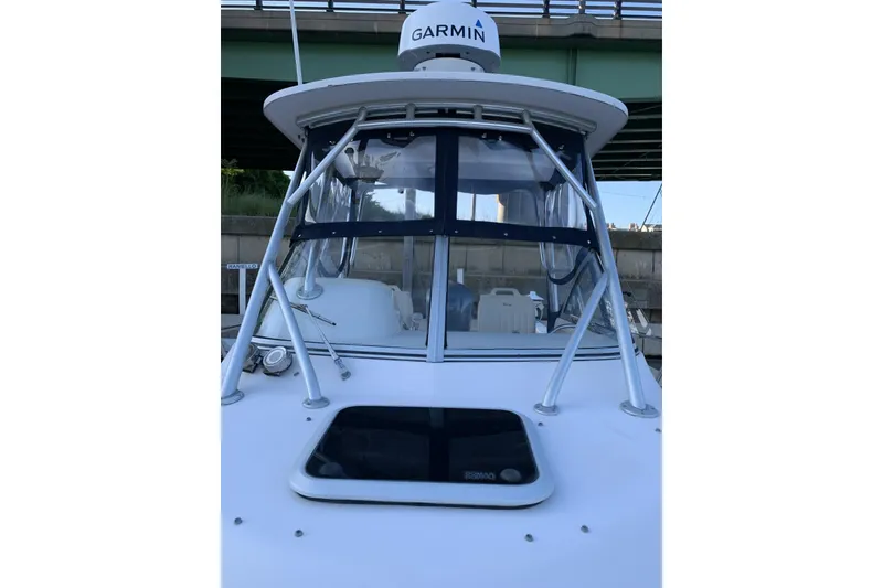 Slide: The Image of 2001 Grady-White Seafarer 226 boat with Garmin radar, docked under a bridge. - 5