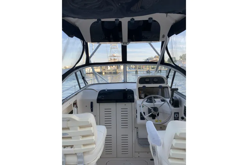 Slide: The Image of Interior view of a 2001 Grady-White Seafarer 226 boat cockpit with steering wheel. - 6