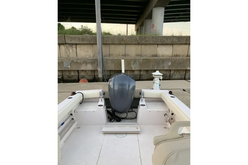 Slide: The Image of 2001 Grady-White Seafarer 226 boat interior with outboard motor under a bridge. - 7