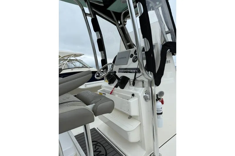 Slide: The Image of 2023 Key West 219 FS boat console with Garmin navigation system and seating. - 3