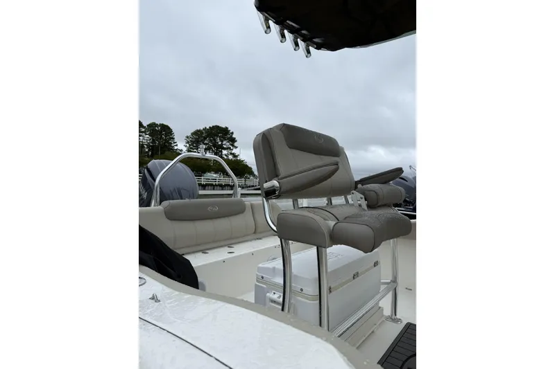 Slide: The Image of 2023 Key West 219 FS boat interior with cushioned seating and storage. - 4