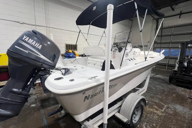 The Image of 2009 NauticStar 1910 NauticBay boat with Yamaha engine on trailer in garage. - 0