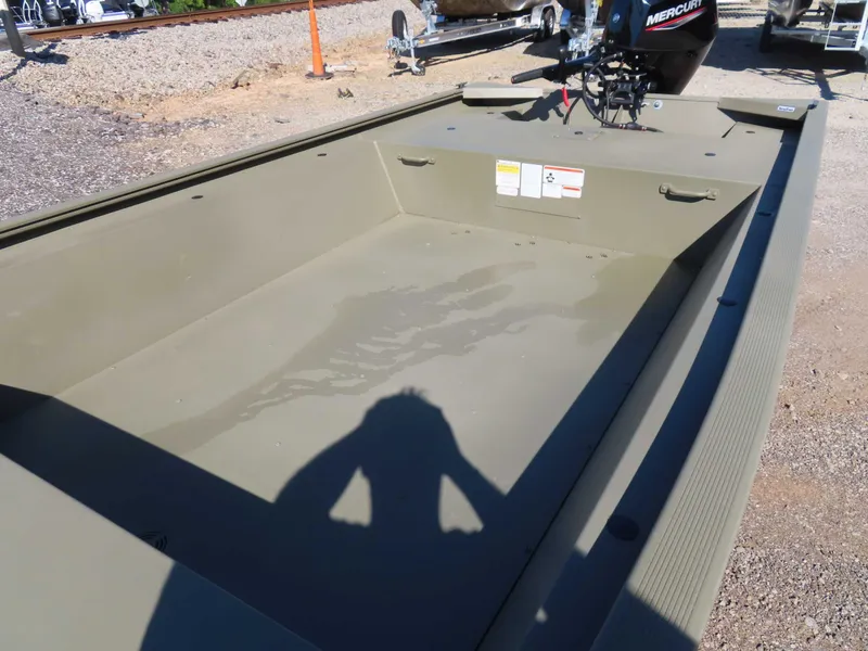 Slide: The Image of 2024 Tracker 1648 AWL boat with outboard motor on gravel surface. - 13