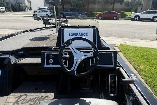 Slide: The Image of 2025 Ranger Z521R Cup-Equipped boat dashboard with Lowrance electronics and steering wheel. - 10