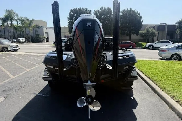 Slide: The Image of 2025 Ranger Z521R Cup-Equipped boat with powerful outboard motor in a parking lot. - 2