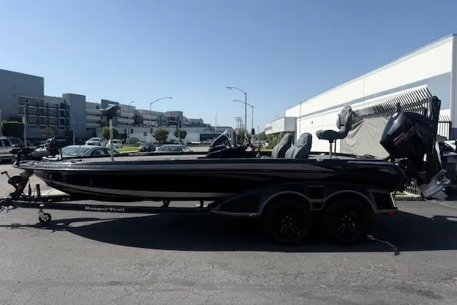 Slide: The Image of 2025 Ranger Z521R Cup-Equipped boat in parking lot, side view, sunny day. - 4