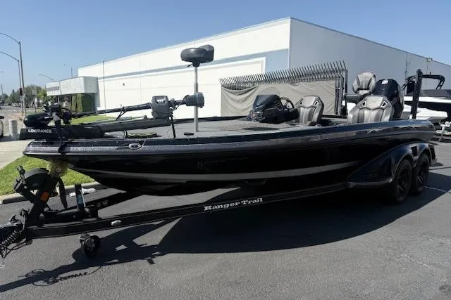 Slide: The Image of 2025 Ranger Z521R Cup-Equipped boat, black, parked outdoors on a trailer. - 5