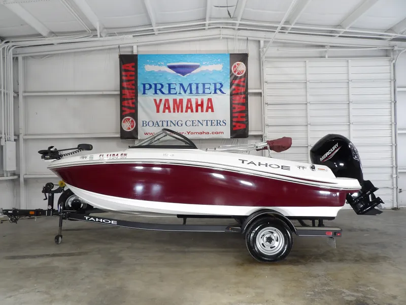 The Image of 2022 Tahoe 185 boat displayed in a showroom. - 1