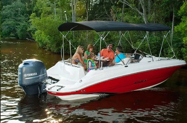 Slide: The Image of 2016 Stingray 192 SC boat on calm water with passengers. - 13