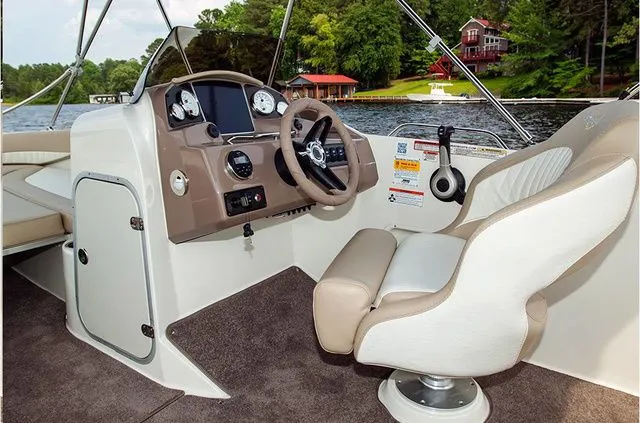 Slide: The Image of Interior of a 2016 Stingray 192 SC boat by the lake. - 16